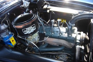 A good example of a detailed engine compartment in a 1954 Pontiac with a straight eight engine. Braided spark plug wires and old style hose clamps would add to the originality, but this is still a nicely done restoration.